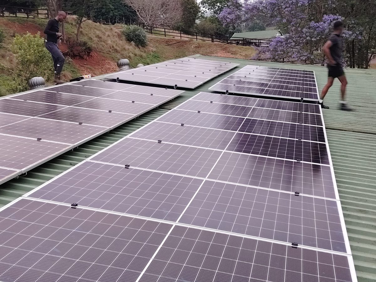 Supreme Solar team installing on residential roof PMB